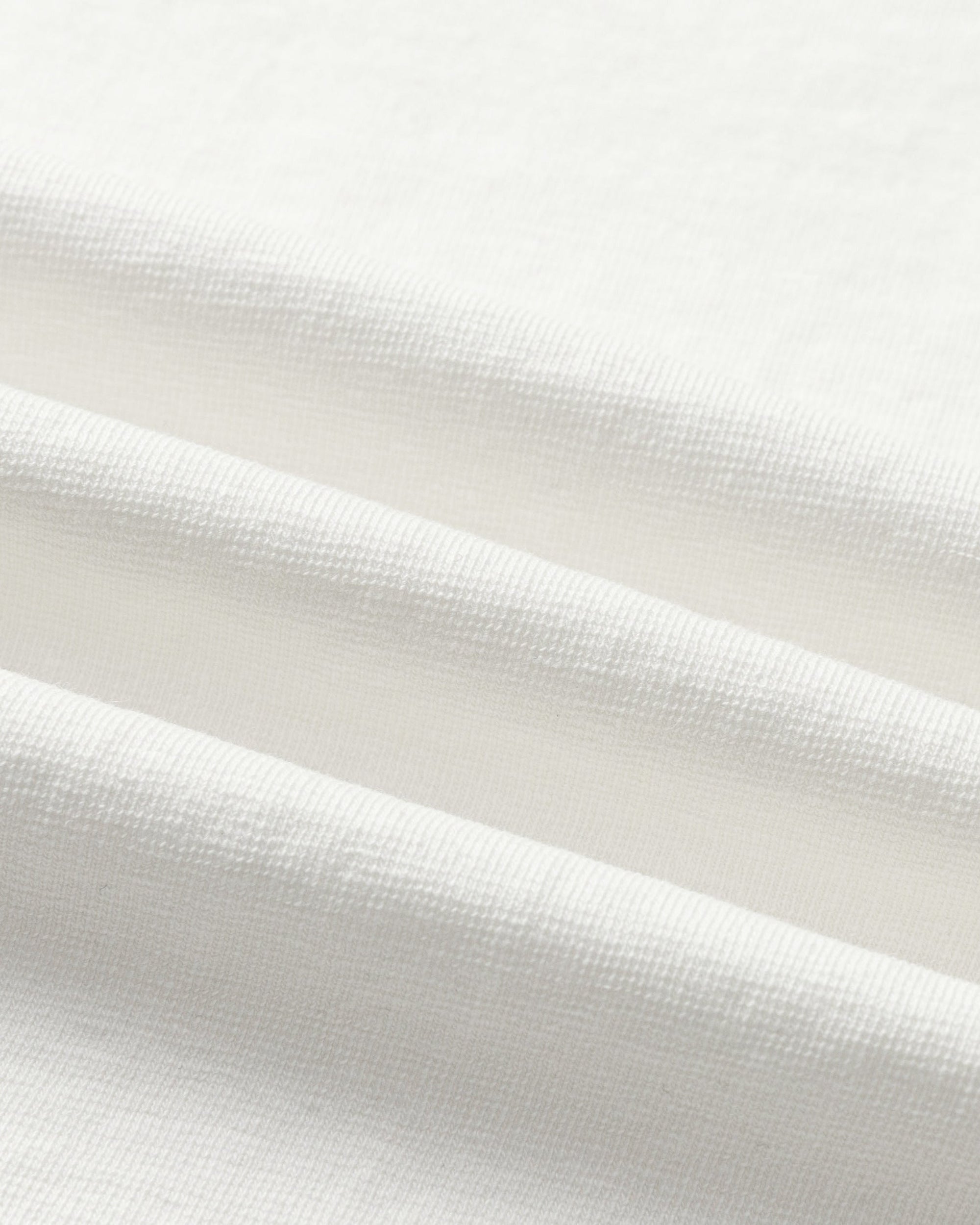 Close-up of hemp–organic cotton stretch knit of Asymmetrical Neckline Tee (white), highlighting breathable texture.