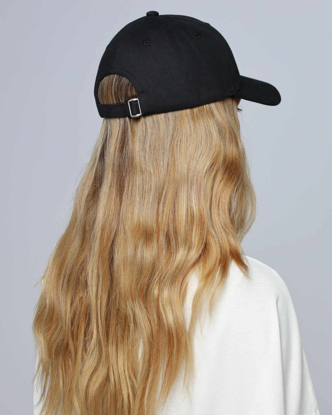 Juana Hemp Essentials Cap (black) on model, back view showing adjustable strap and clean finishing.