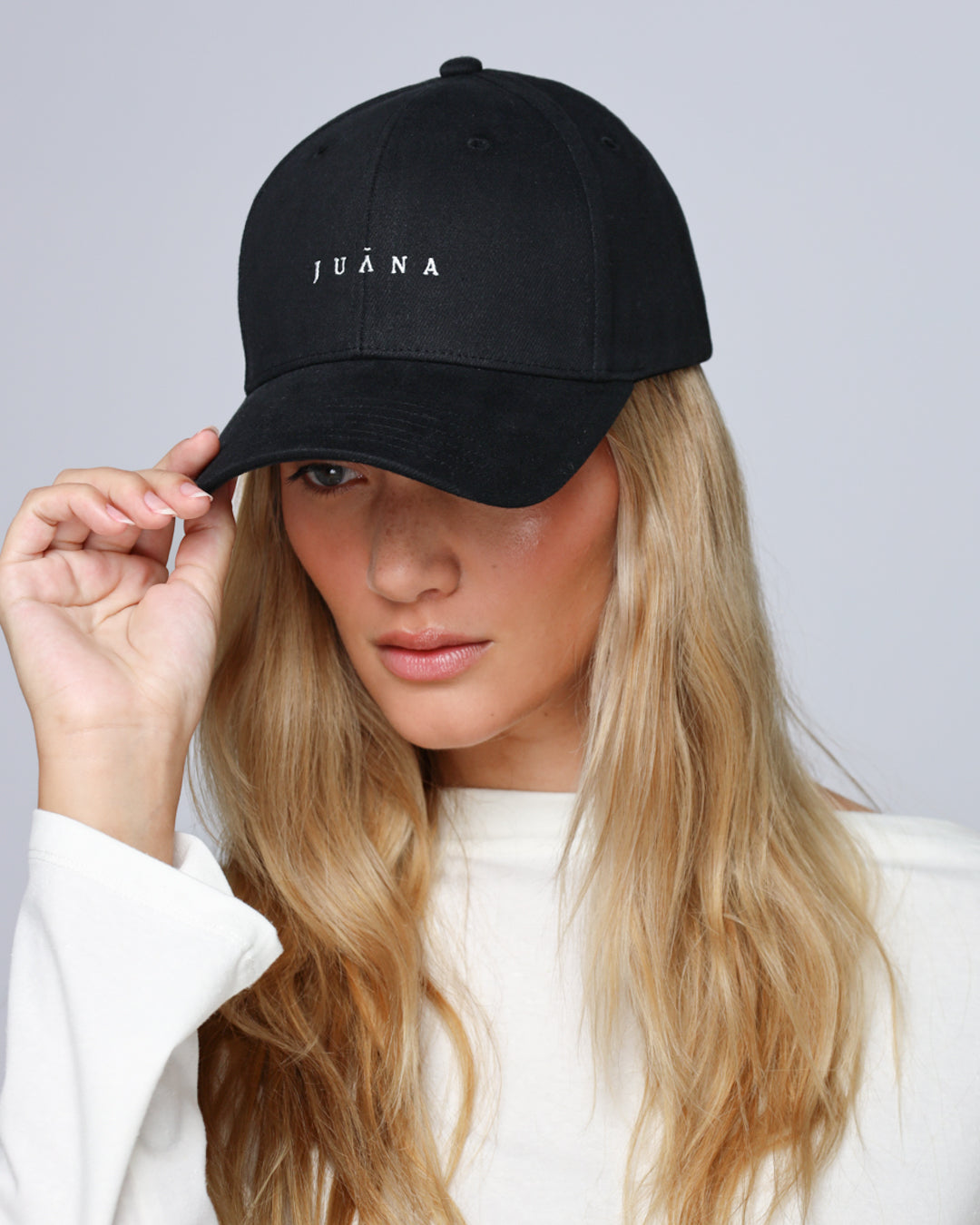 Detail shot of brim stitching, panel seams, and adjustable back strap on the Hemp Essentials Cap (black).