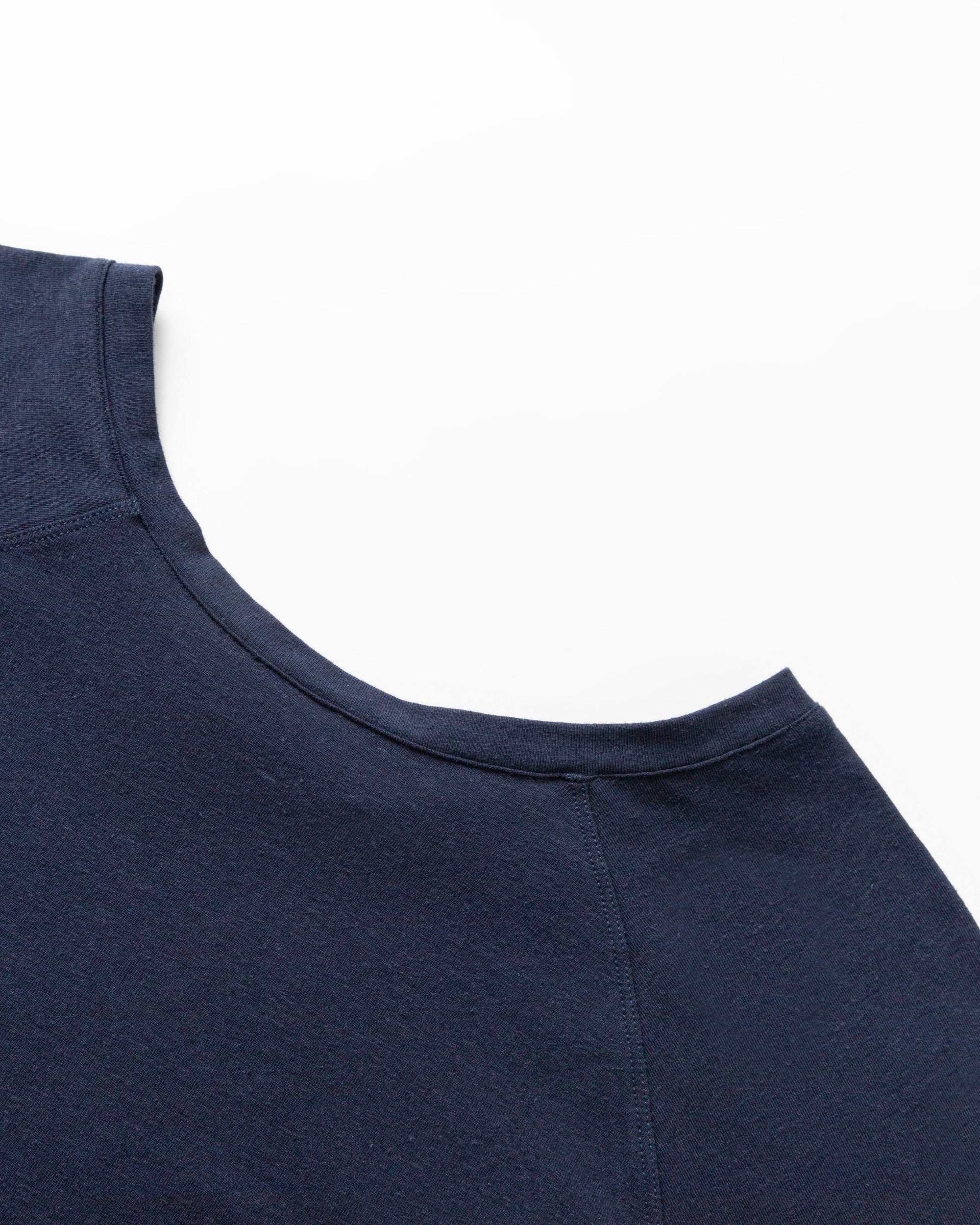 Detail shot of raglan seam and neckline finish on Cropped Raglan Tee (indigo blue).