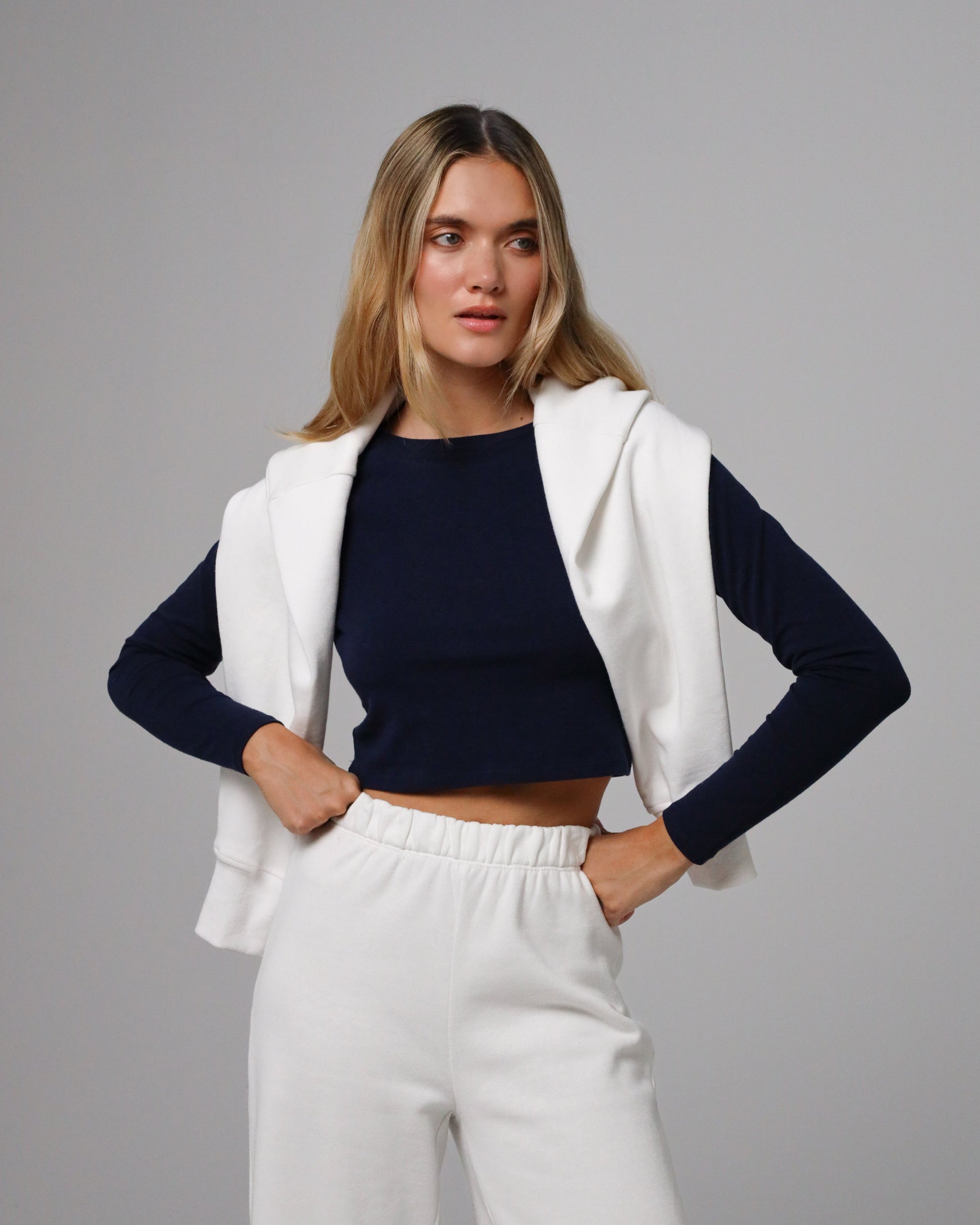 Model styling Cropped Raglan Tee (indigo blue) with high-rise trousers for minimalist polish.
