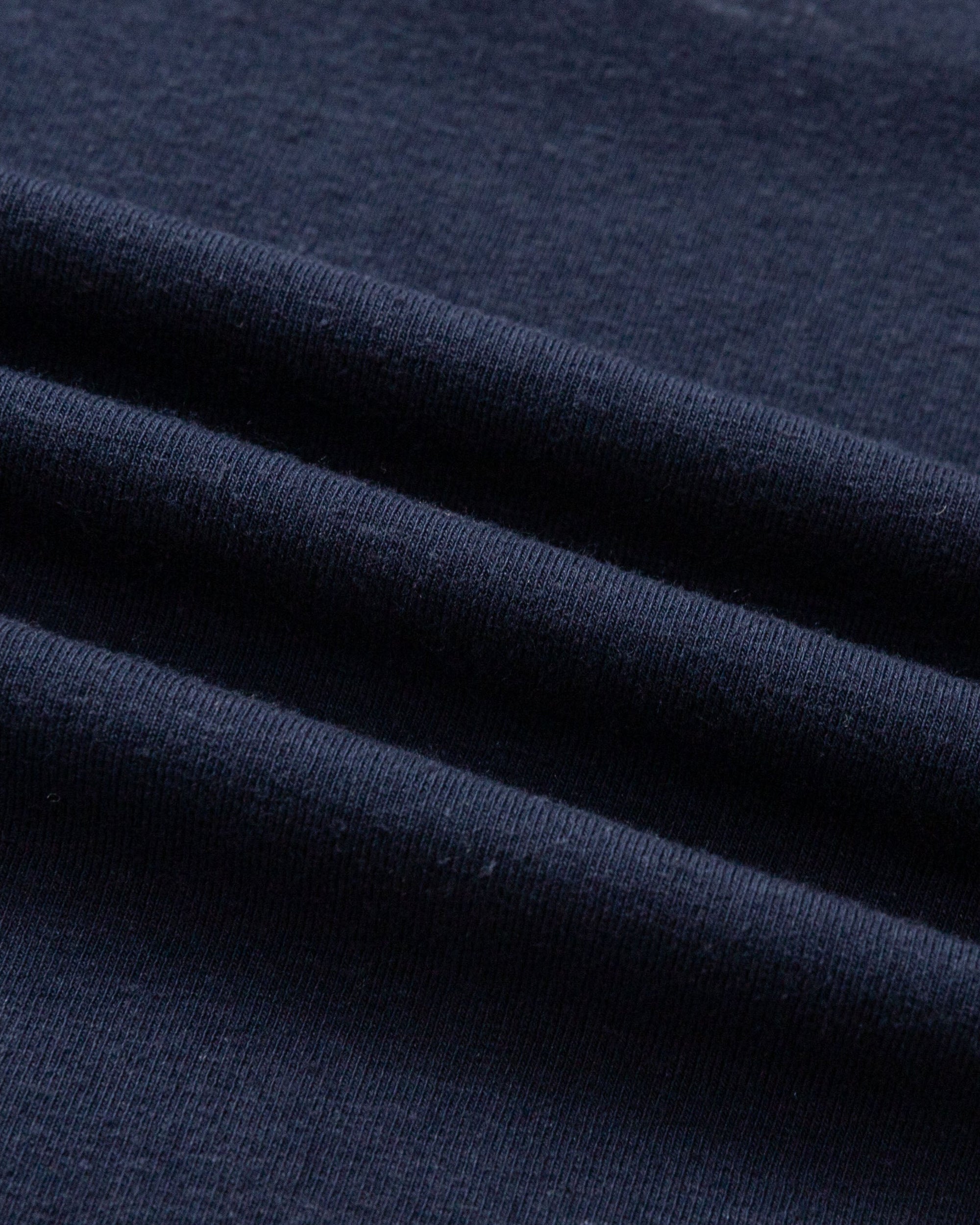 Close-up of hemp–organic cotton stretch knit of Cropped Raglan Tee (indigo blue), highlighting breathable texture.