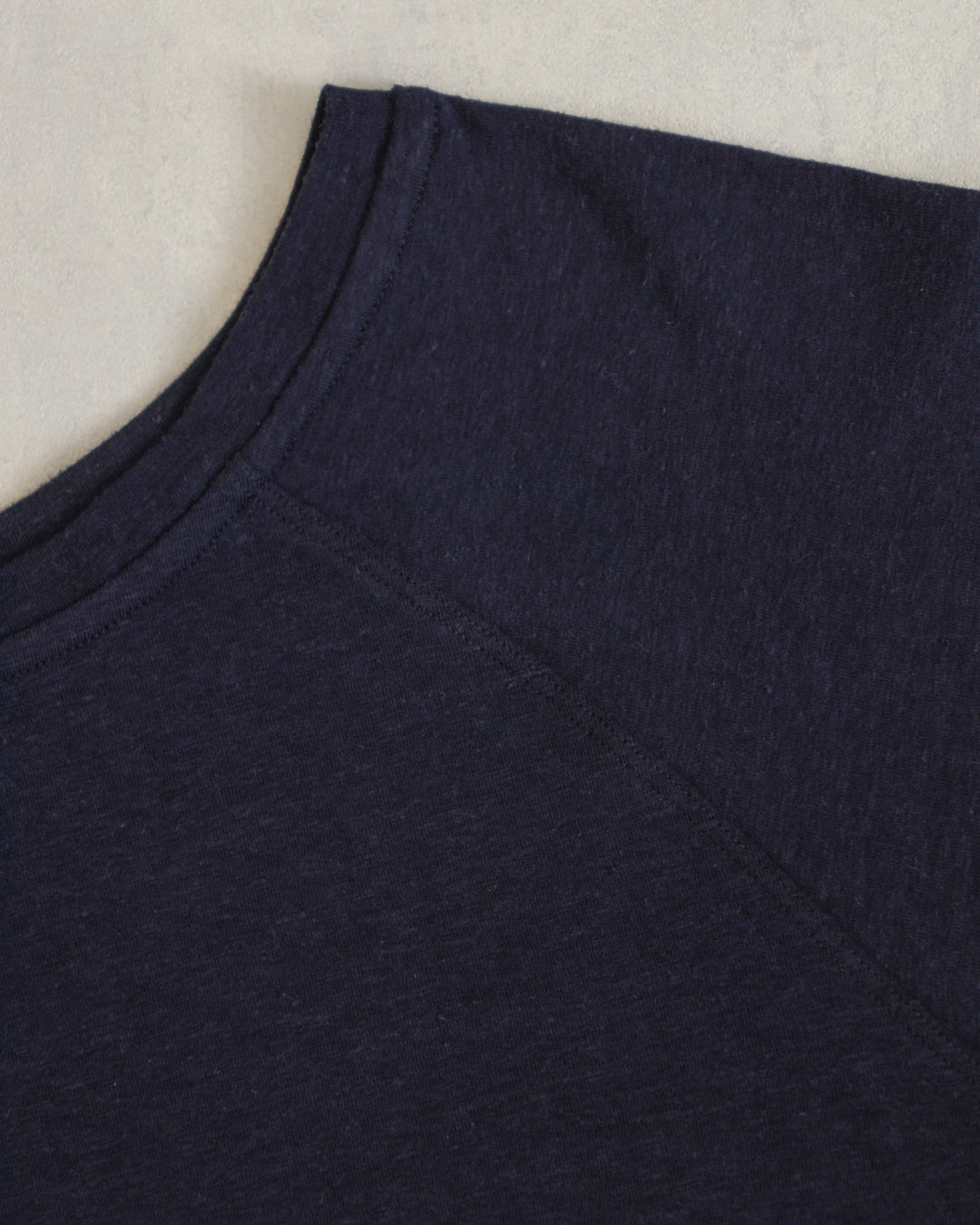Flat lay of the Cropped Raglan Tee showing fabric texture and stitching details.