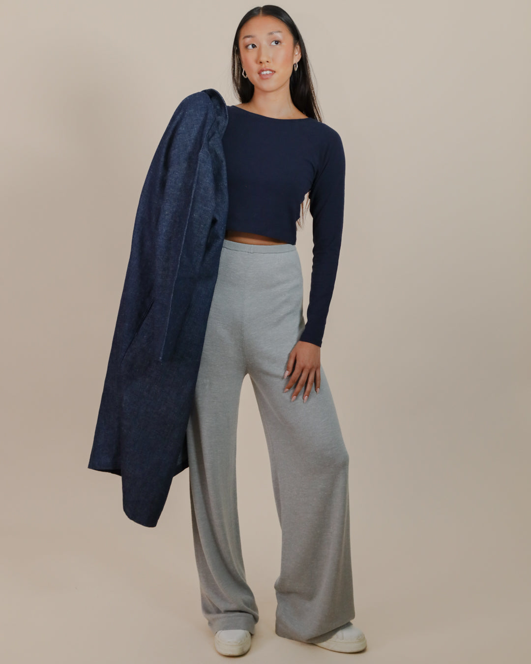 Model styling the Cropped Raglan Tee with wide-leg trousers for a modern, sustainable women’s outfit.