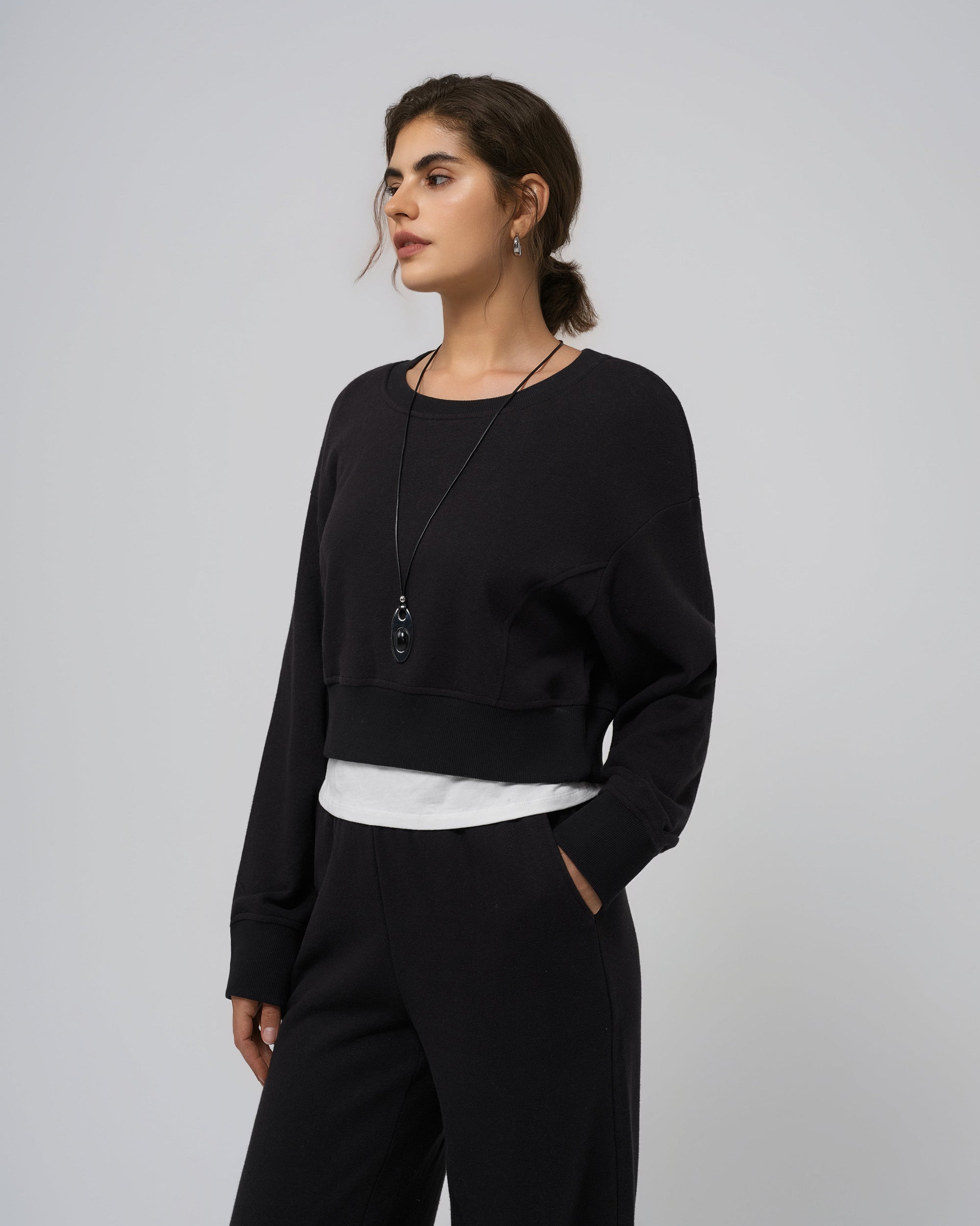 Model wearing black Hemp Essentials Fleece Cropped Sweater (hemp–organic cotton); straight-on front view.