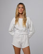 Woman wearing Fleece Shorts in white hemp–organic cotton blend, styled for sustainable everyday wear.