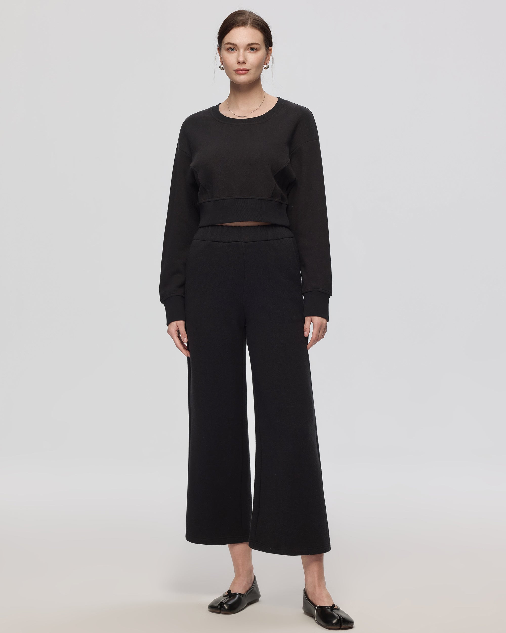 Model wearing black Hemp Essentials Fleece Sweatpants (hemp–organic cotton); 7/8 length