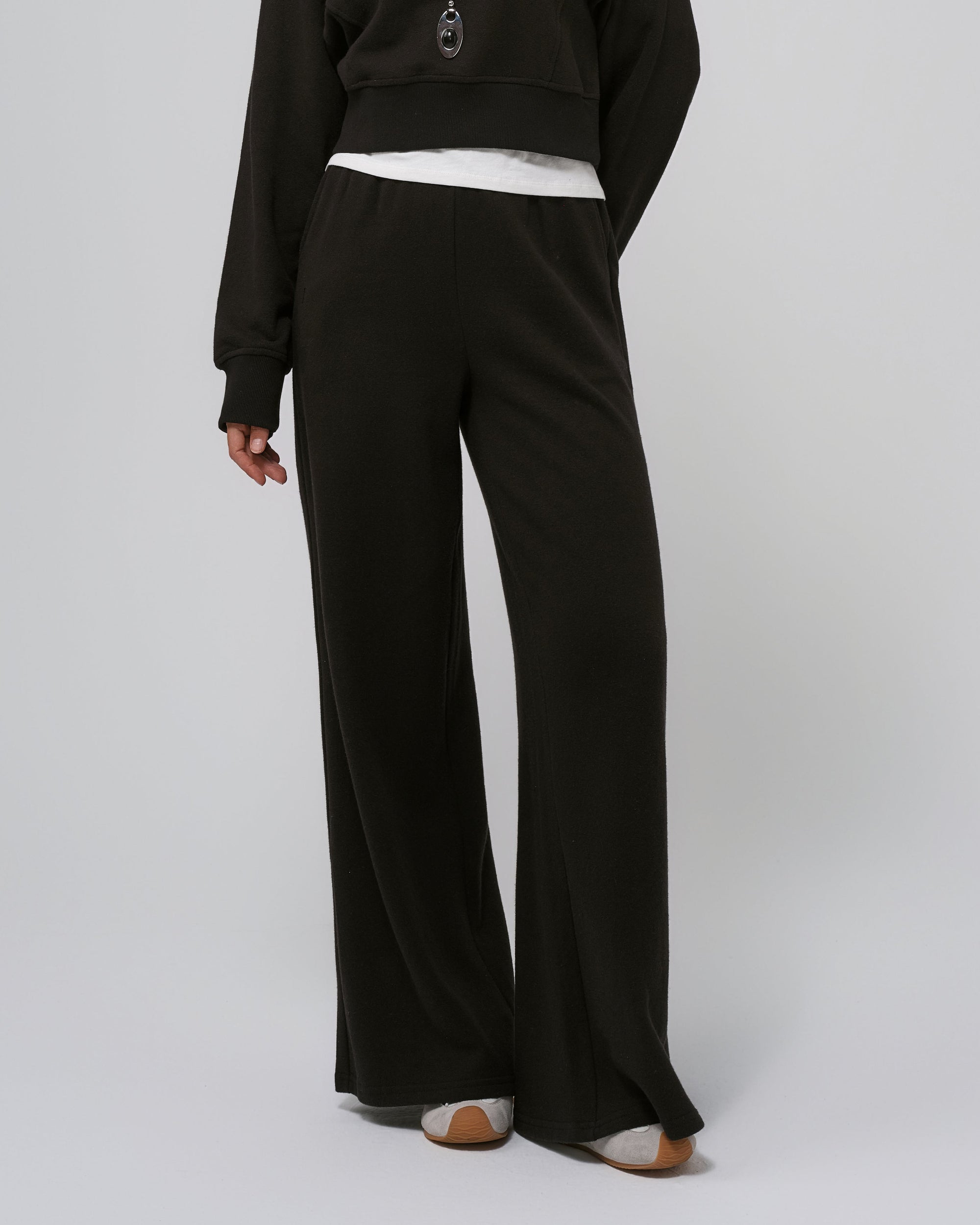 Model wearing black Hemp Essentials Fleece Sweatpants (hemp–organic cotton); straight‑on front.