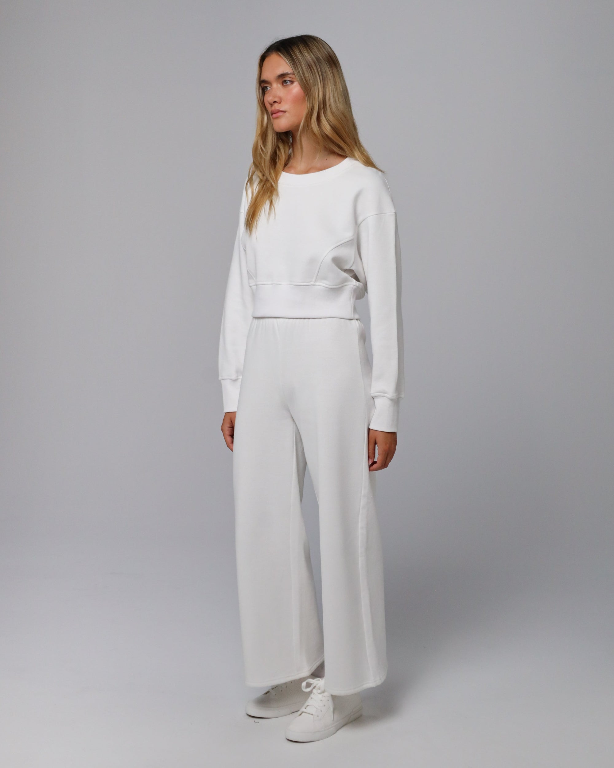 Model wearing white Hemp Essentials Fleece Sweatpants (hemp–organic cotton); side view