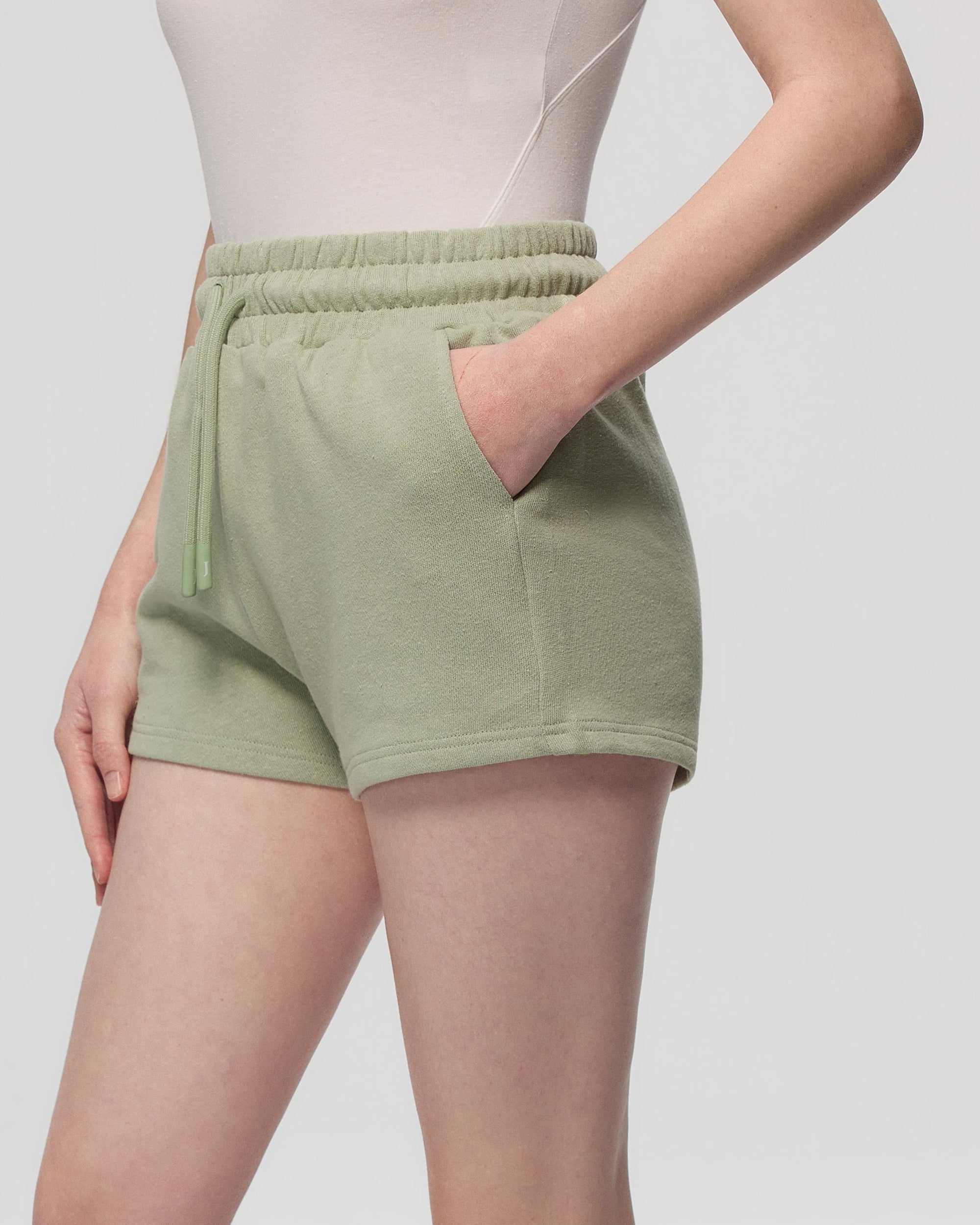 Juana Hemp Essentials French Terry Shorts light sage (sustainable hemp–organic cotton) model detail showing French terry surface and waistband finish