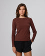 Woman wearing Juana Hemp Essentials Long Sleeve Tee in cocoa hemp–organic cotton blend, styled for sustainable everyday wear.