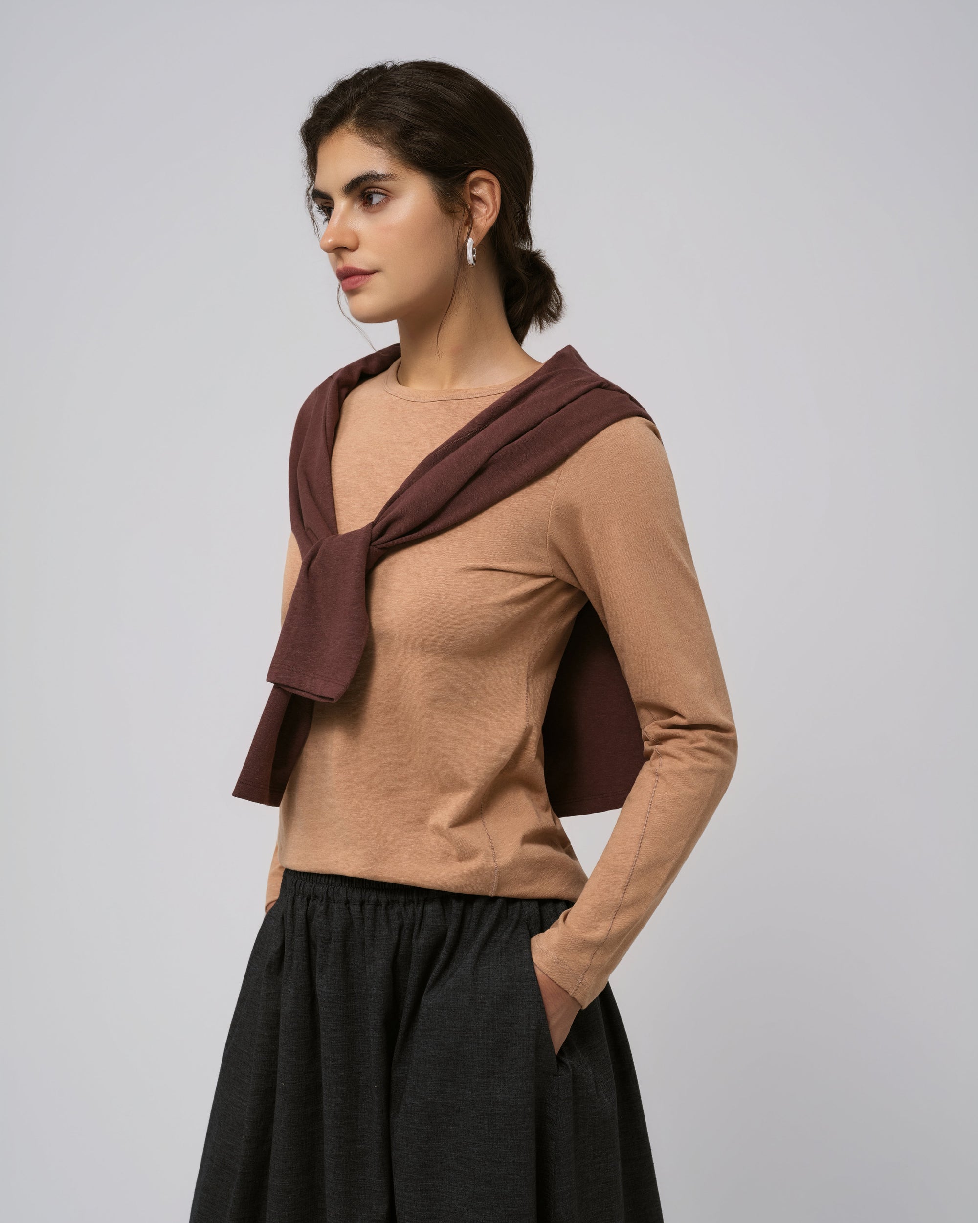 Detail of crewneck, shoulder seam, and scoop hem on Juana Hemp Essentials Long Sleeve Tee fawn (hemp–organic cotton).