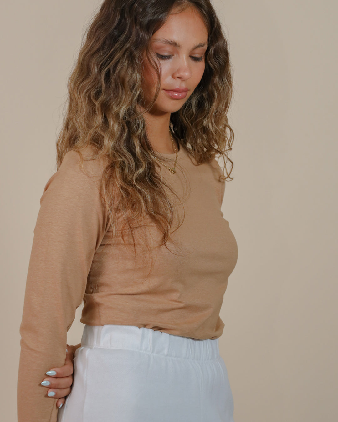 Close-up of scoop hem and seam construction, showing craftsmanship and fabric quality.
