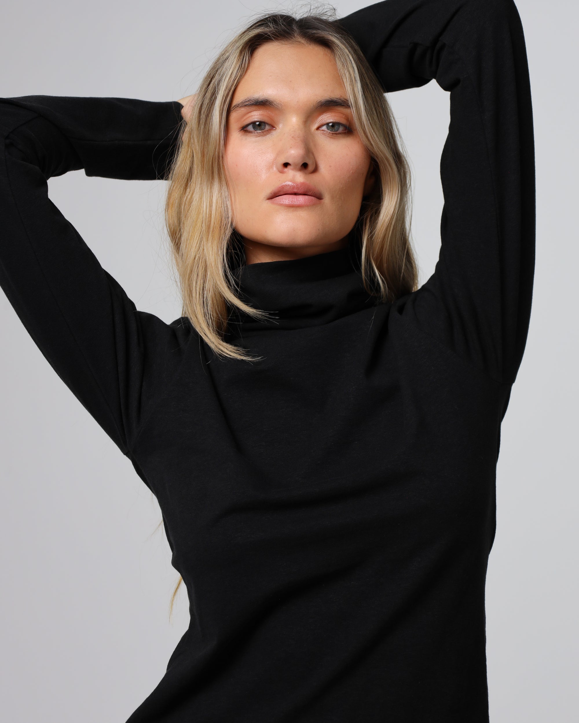 Detail shot of the mockneck collar and shoulder seam on the Hemp Essentials Mockneck (black).