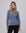 Model styling the Mockneck (blue) with tailored trousers for a sleek, minimalist look.