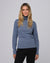 Model styling the Mockneck (blue) with tailored trousers for a sleek, minimalist look.
