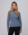 Model styling the Mockneck (blue) with tailored trousers for a sleek, minimalist look.
