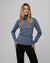 Woman wearing Juana Hemp Essentials Mockneck in blue hemp–organic cotton stretch blend, styled for sustainable everyday wear.