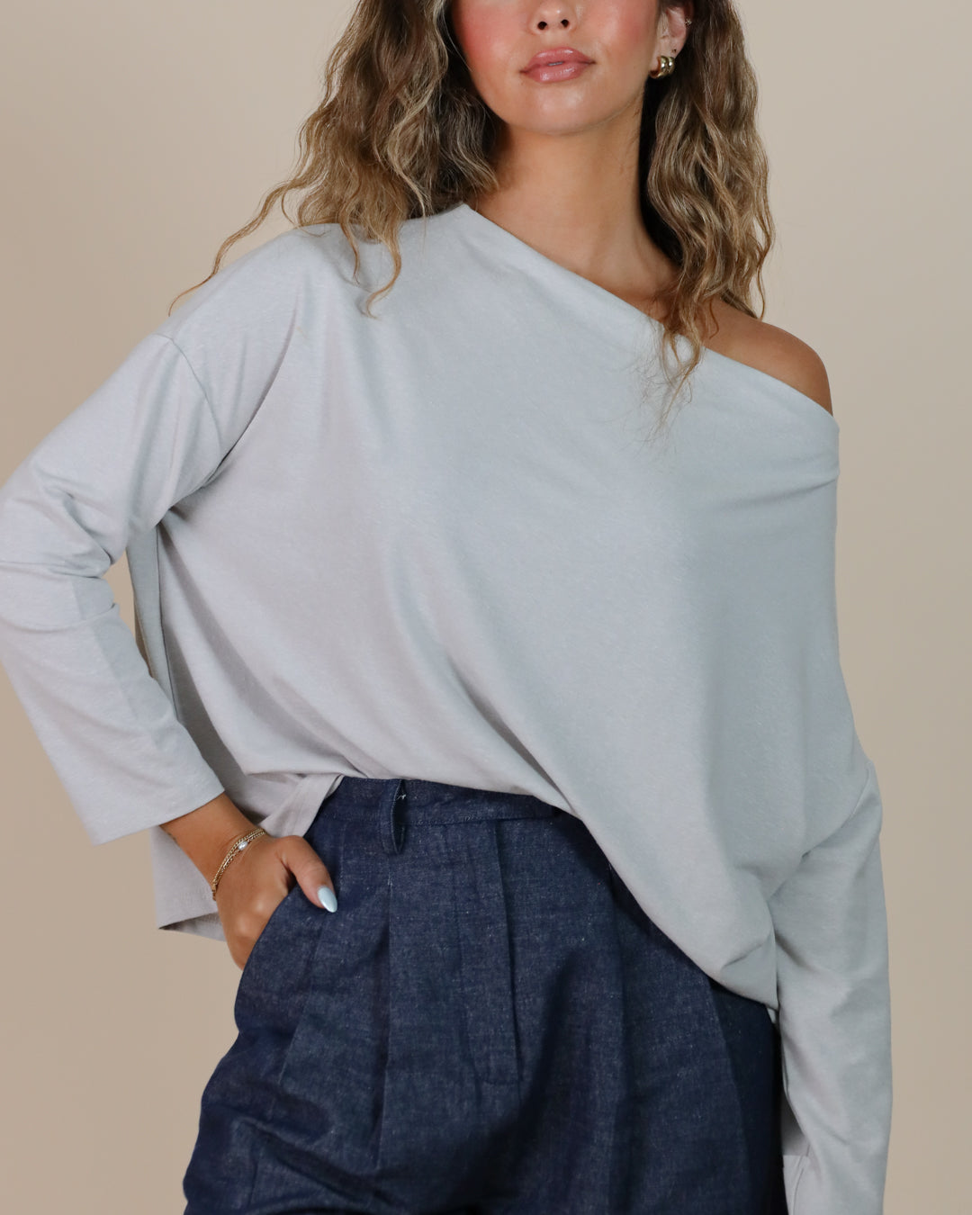 Close-up of neckline and seam on Juana Hemp Essentials Off The Shoulder Top in ash, showcasing precision tailoring and fabric quality.