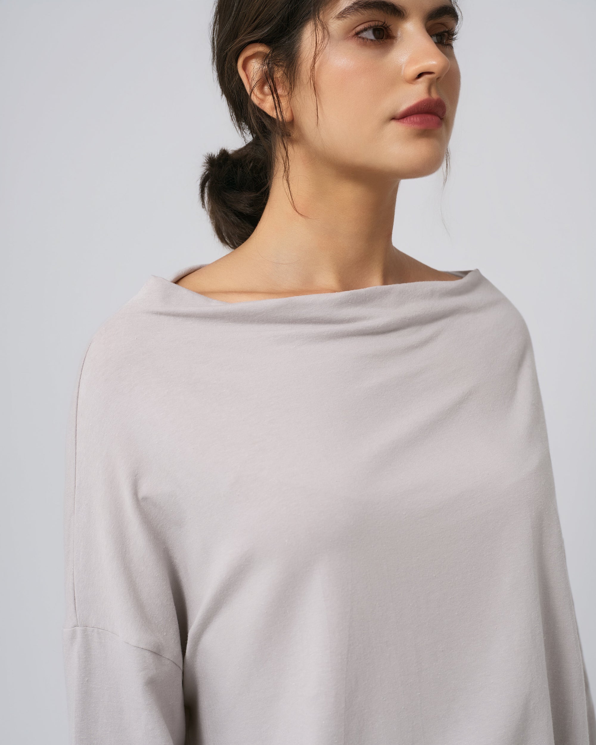 Detail of off-shoulder neckline, hem, and seam finish on ash hemp–organic cotton top.