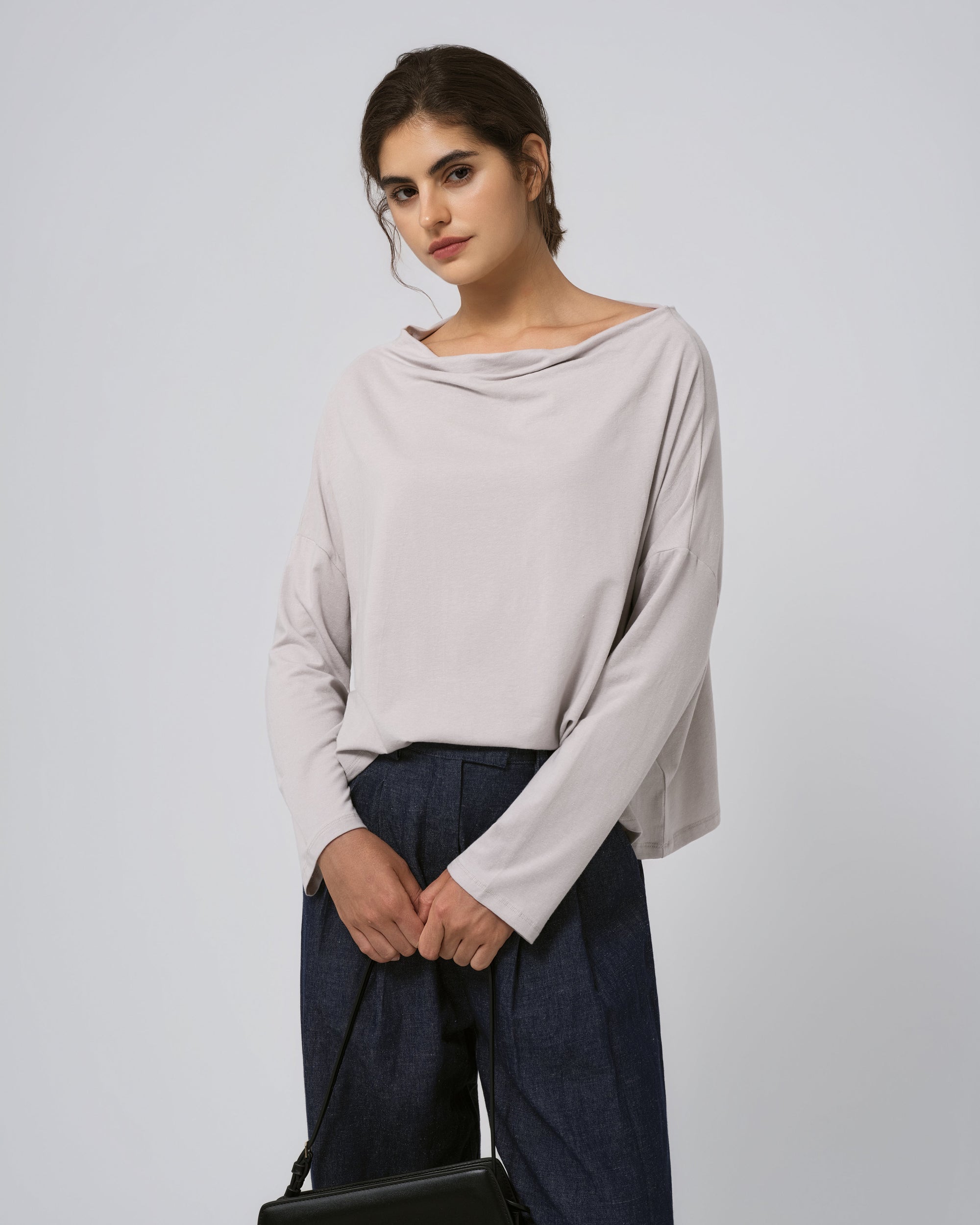 Model wearing Juana Hemp Essentials Off The Shoulder Top in ash (hemp–organic cotton blend), showing off-shoulder neckline and clean silhouette.