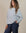 Woman wearing Juana Hemp Essentials Off The Shoulder Top in ash, showcasing sustainable hemp blend long sleeve style.