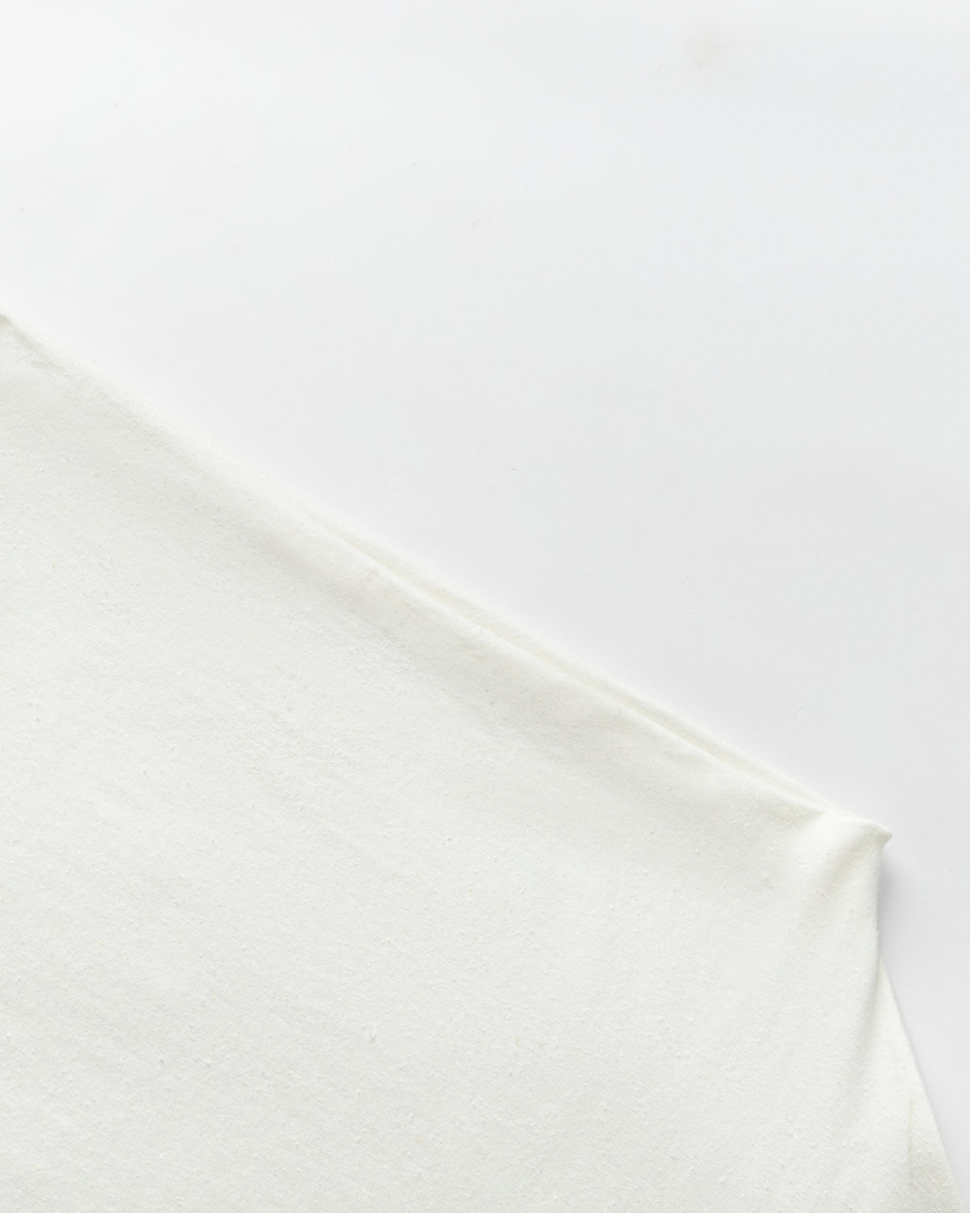 Detail shot of off-shoulder neckline and sleeve finish on Off The Shoulder Top (white).