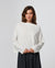 Woman wearing Juana Hemp Essentials Off The Shoulder Top in white hemp–Tencel™ blend, styled for sustainable everyday wear.