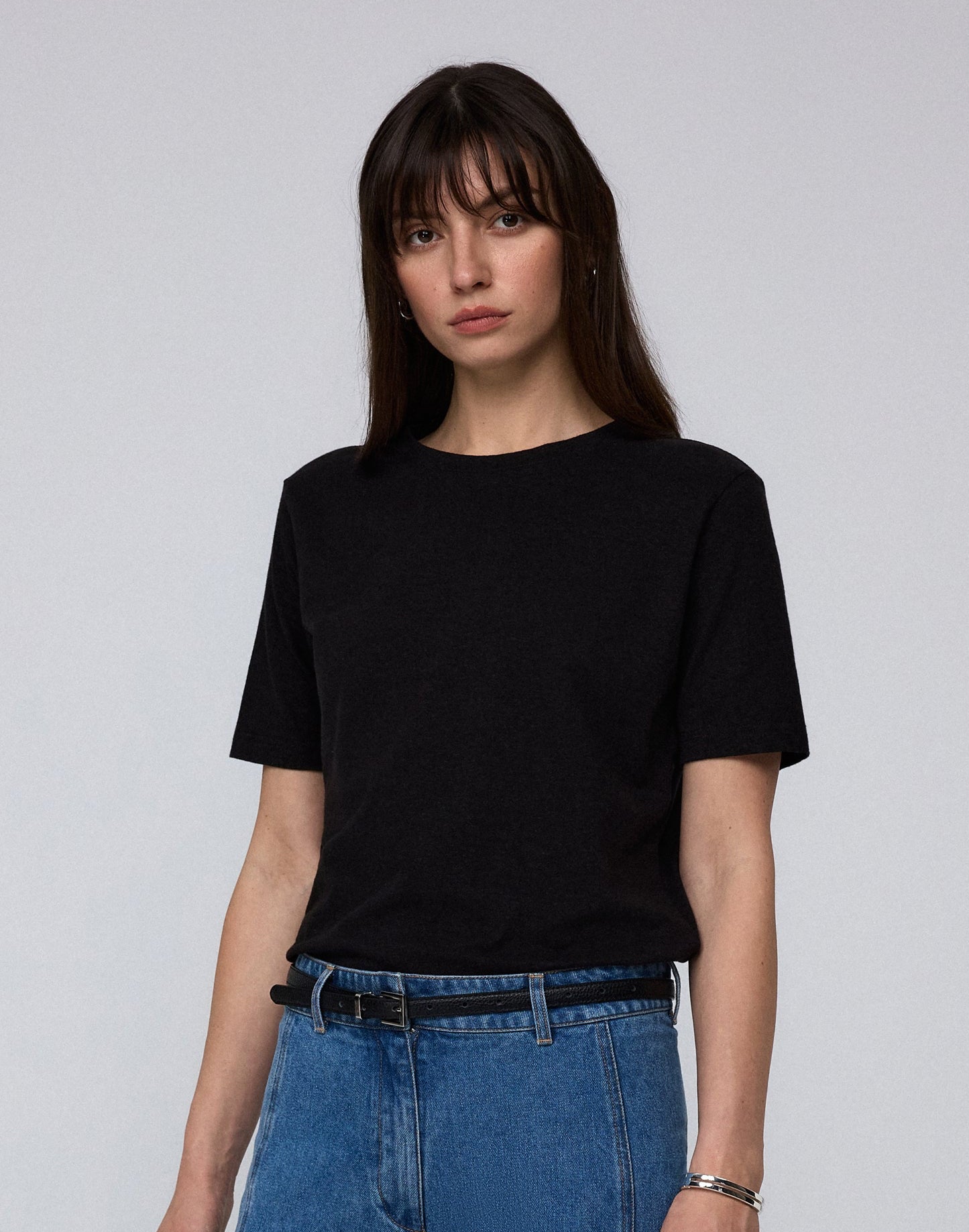 Model wearing Juana Hemp Essentials Short Sleeve Tee in black hemp–organic cotton stretch blend, styled for sustainable everyday wear.