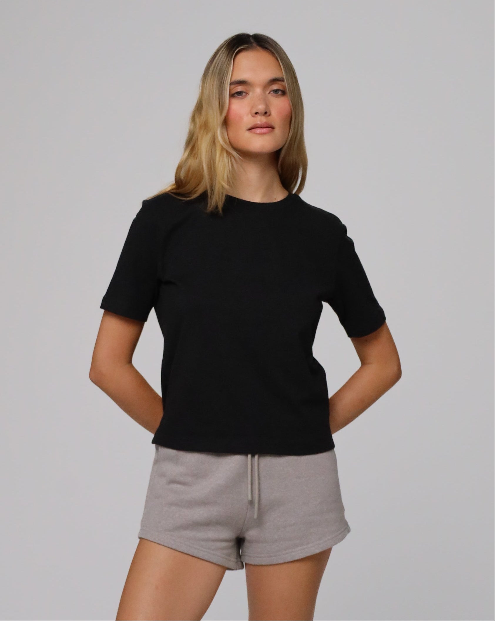 Model wearing Juana Hemp Essentials Short Sleeve Tee in black hemp–organic cotton stretch blend, styled for sustainable everyday wear.