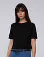 Model wearing Juana Hemp Essentials Short Sleeve Tee in black hemp–organic cotton stretch blend, styled for sustainable everyday wear.