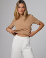 Woman wearing Juana Hemp Essentials Short Sleeve Tee in fawn hemp–organic cotton stretch blend, styled for sustainable everyday wear.