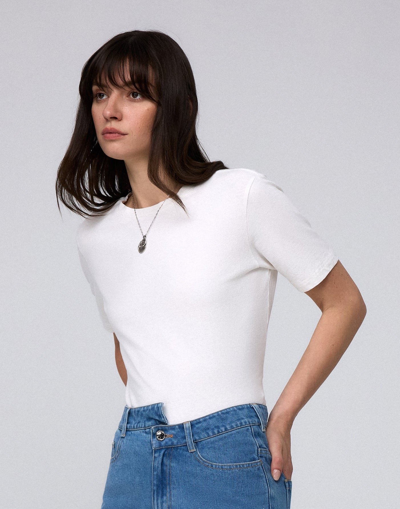 Detail shot of crew neckline and seam finishing on Short Sleeve Tee (white).