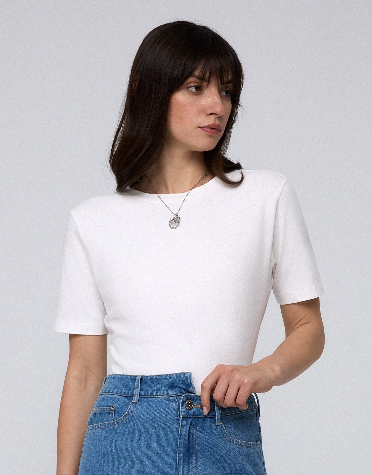 Woman wearing Juana Hemp Essentials Short Sleeve Tee in white hemp–organic cotton stretch blend, styled for sustainable everyday wear.