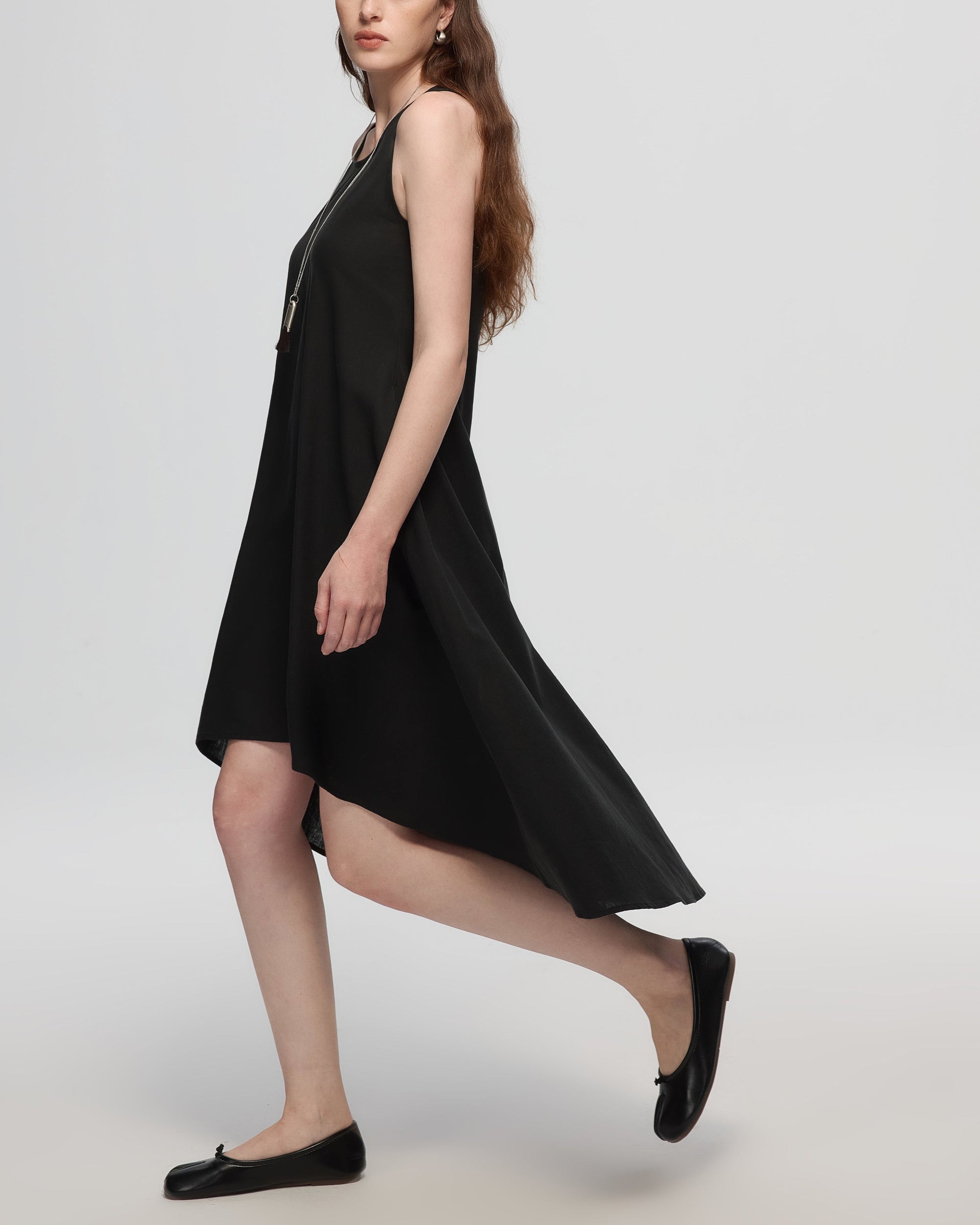 Juana Hemp High Low Dress black (hemp–cotton) on model side view showing high-low hemline