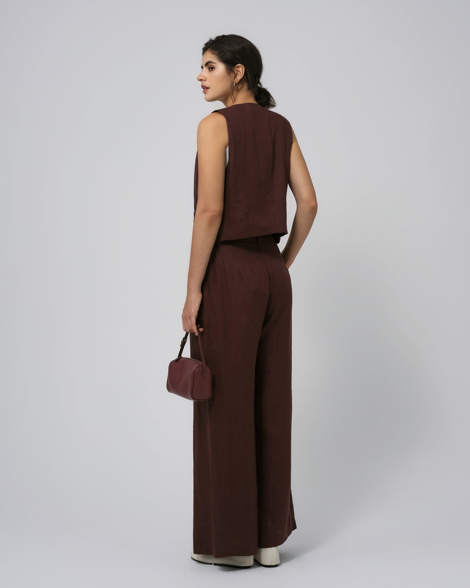 Model back view of expresso high-rise hemp pants; clean yoke and back seam.