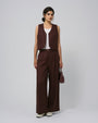 Model wearing Juana Hemp High Rise Pants in expresso (100% hemp) with corozo button closure; relaxed tapered leg.