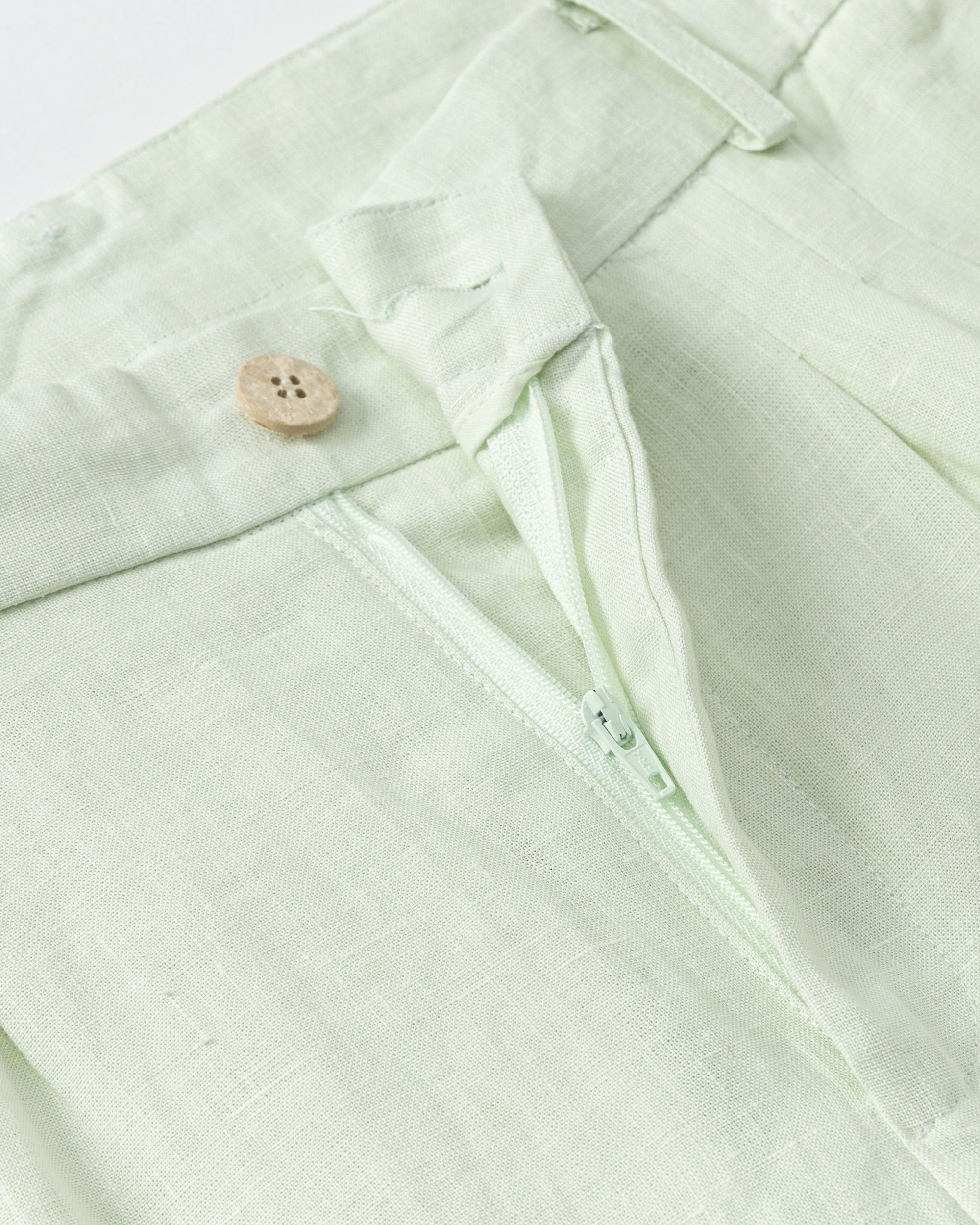 Juana Hemp High Rise Pants Light Mint (hemp) showing corozo button closure and front finish.