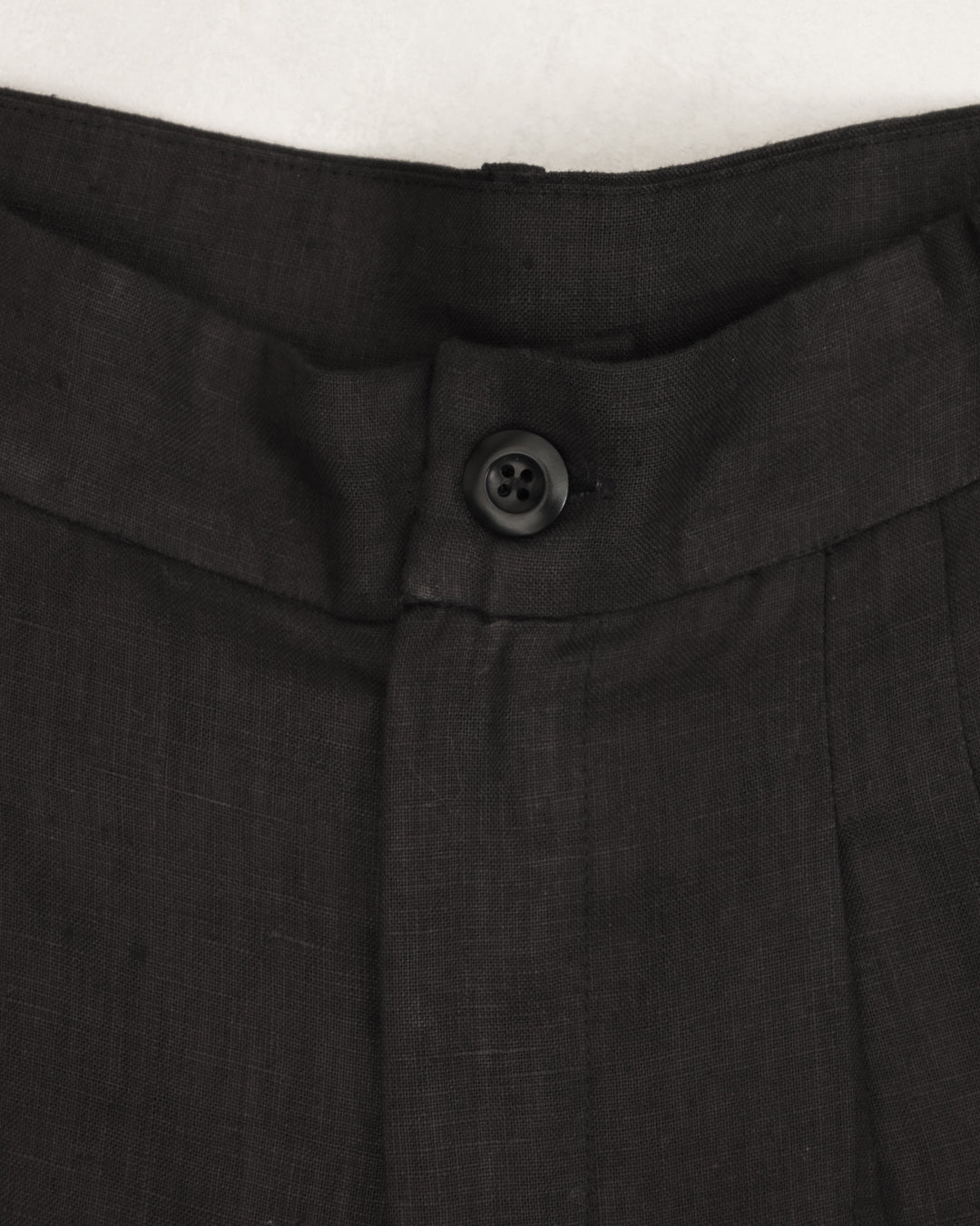 Flat lay close up of Juana Hemp High Rise Pants, showing texture and corozo button details.