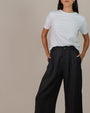 Woman wearing Juana Hemp High Rise Pants, tailored from 100% hemp in a flattering high-rise silhouette.