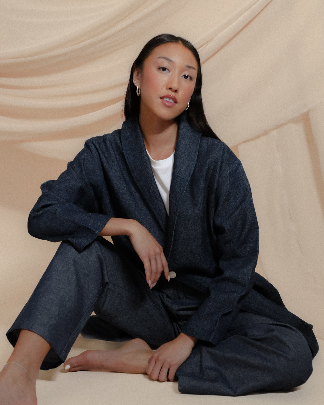 Model wearing Juana Hemp High Rise Trousers in natural hemp and organic cotton blend, styled for a relaxed yet tailored look.