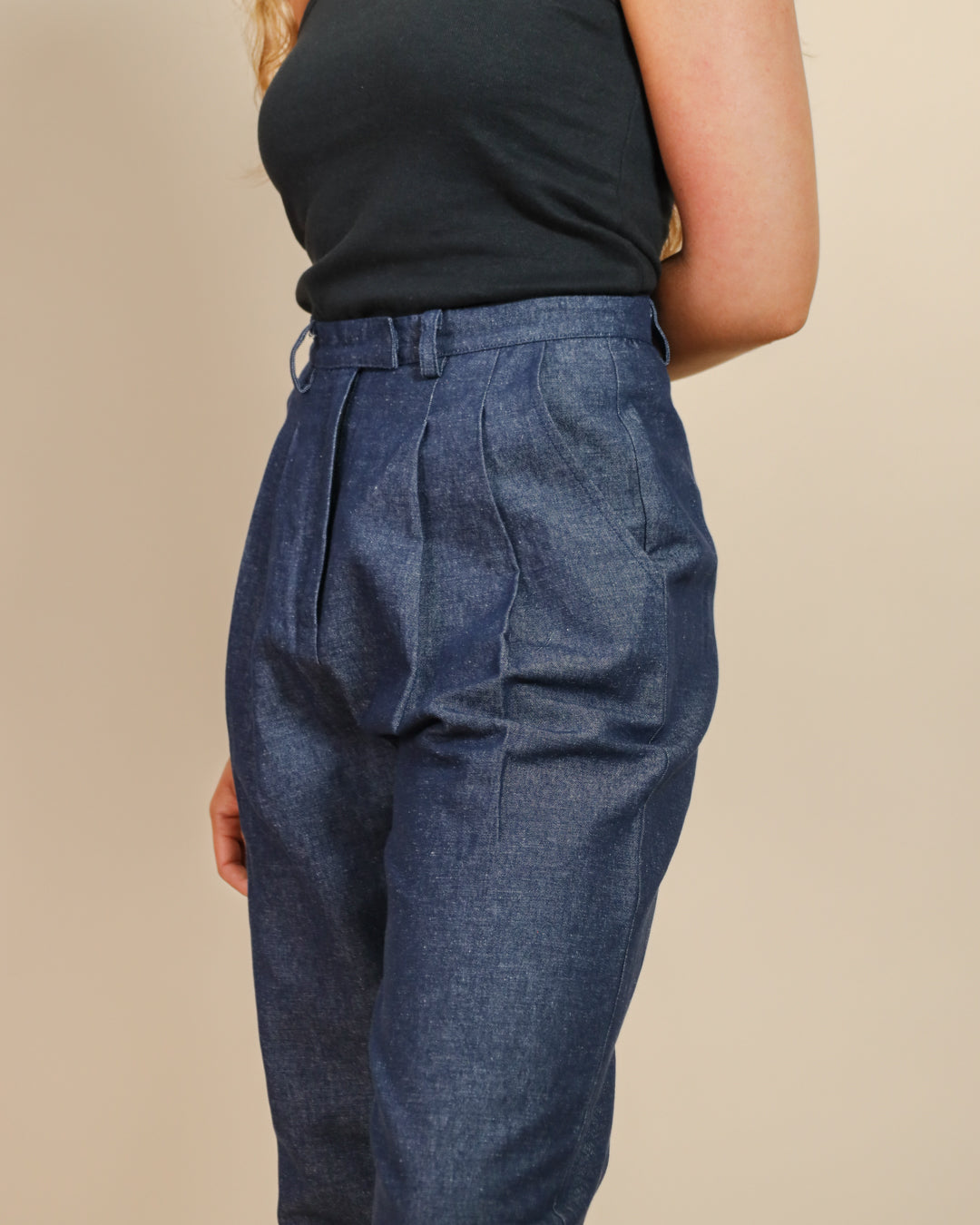 Model pairing Juana Hemp High Rise Trousers with a casual knit, highlighting versatile styling.