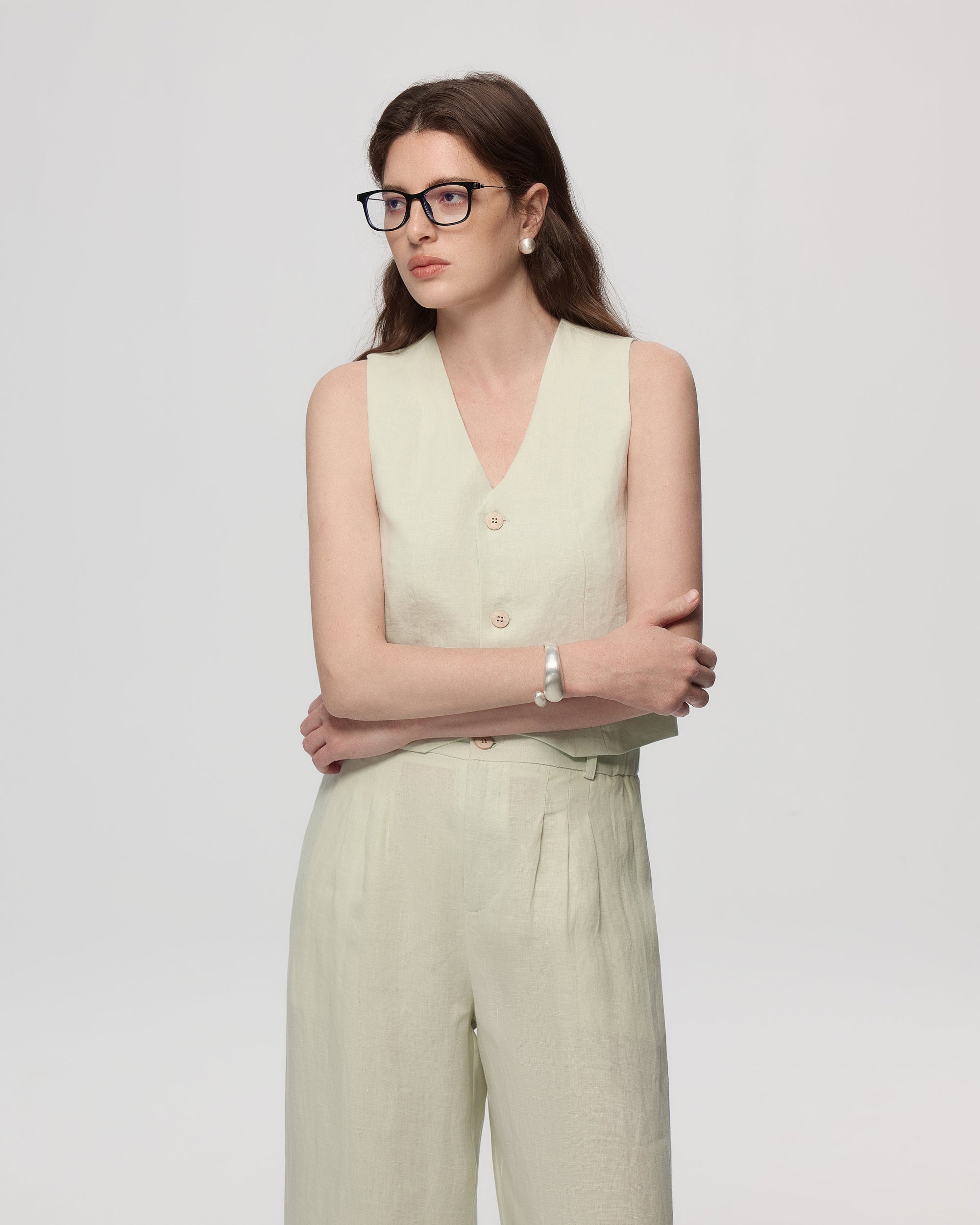 Model wearing Juana Hemp Tailored Vest in light mint (hemp), styled for polished layering with a minimal silhouette.