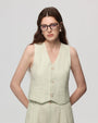 Model wearing Juana Hemp Tailored Vest in light mint (hemp), showing tailored fit and clean V-neck front.