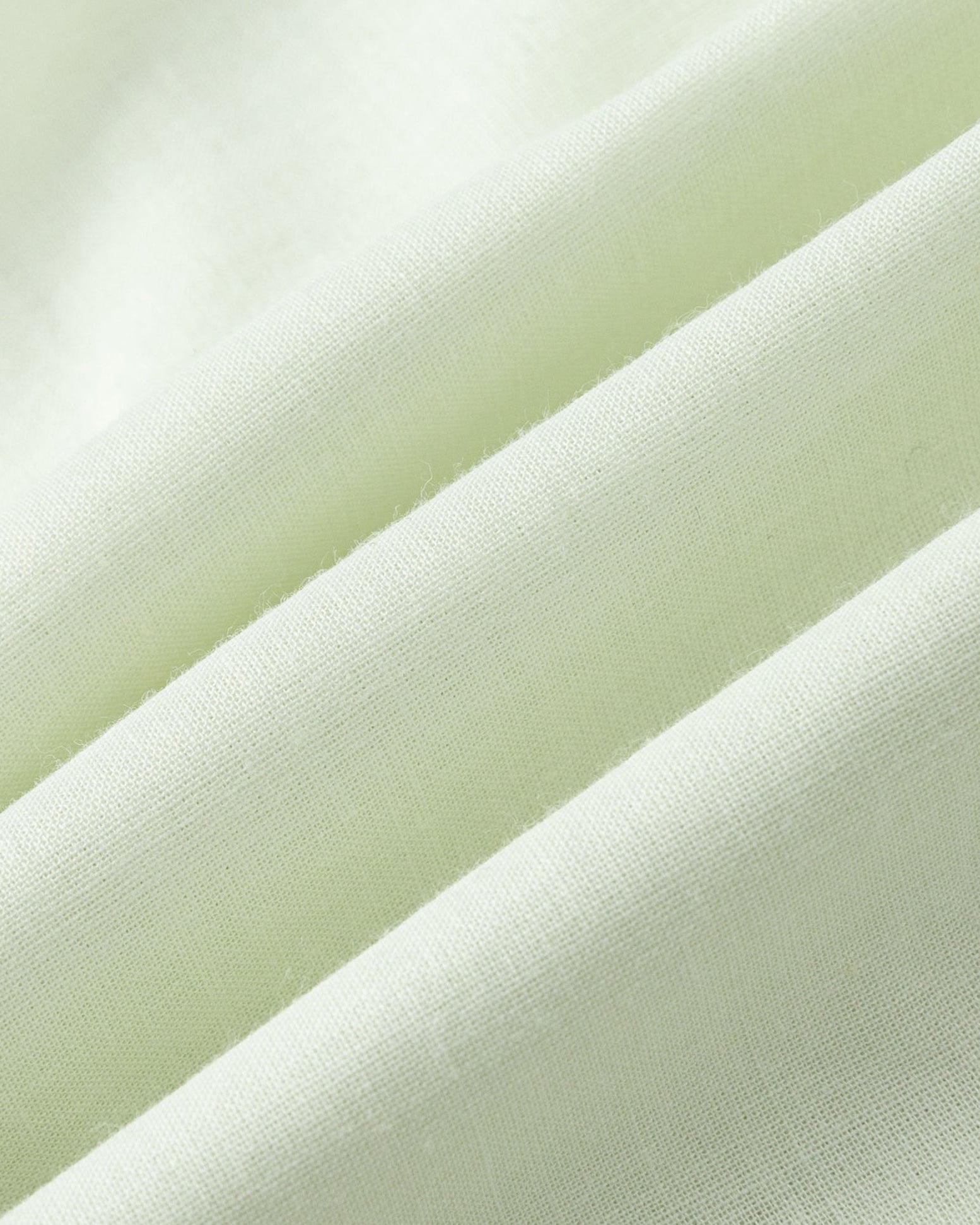 Close-up of Juana Hemp Tailored Vest fabric in light mint (hemp), highlighting woven texture and natural structure.