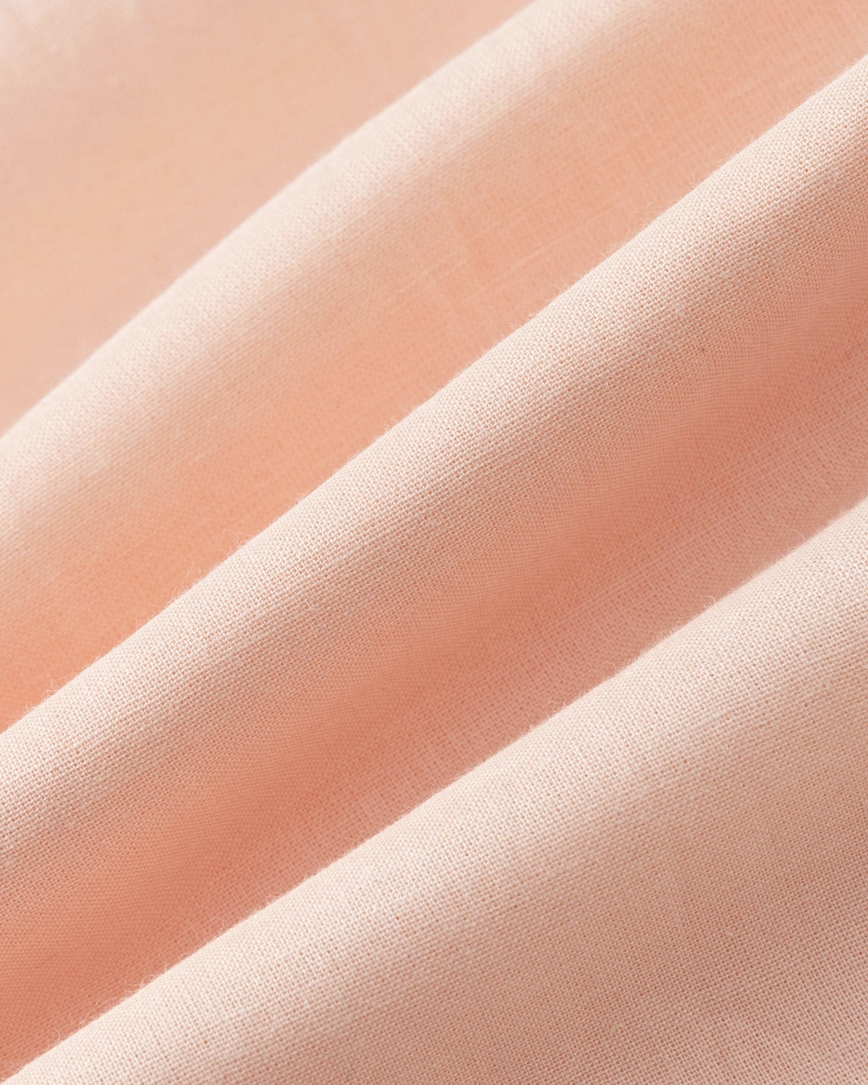 Close-up of Juana Hemp Tailored Vest fabric in light peach (hemp), highlighting woven texture and natural structure.