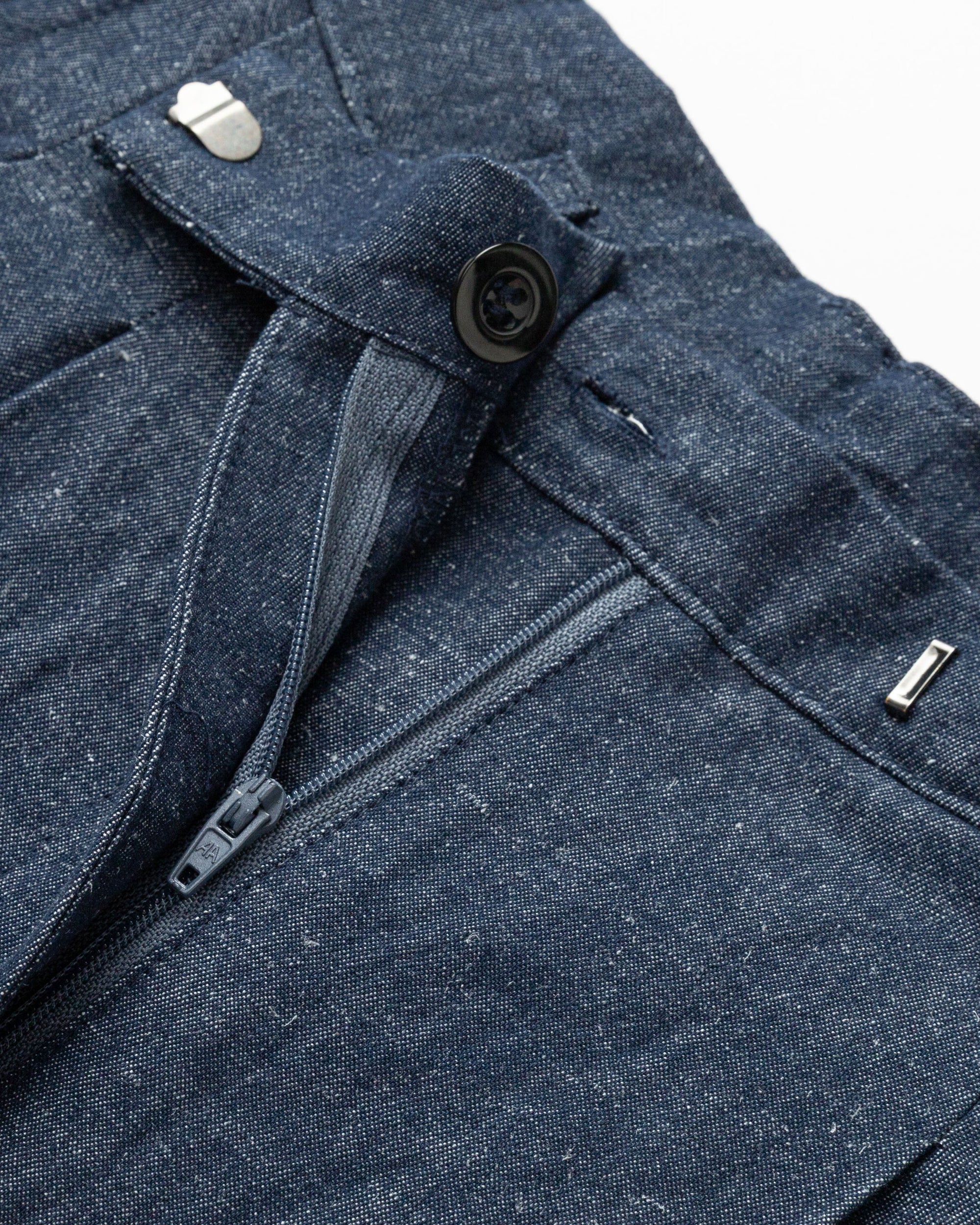 Detail shot of stitching and finishing on Juana High Rise Trousers (indigo denim).