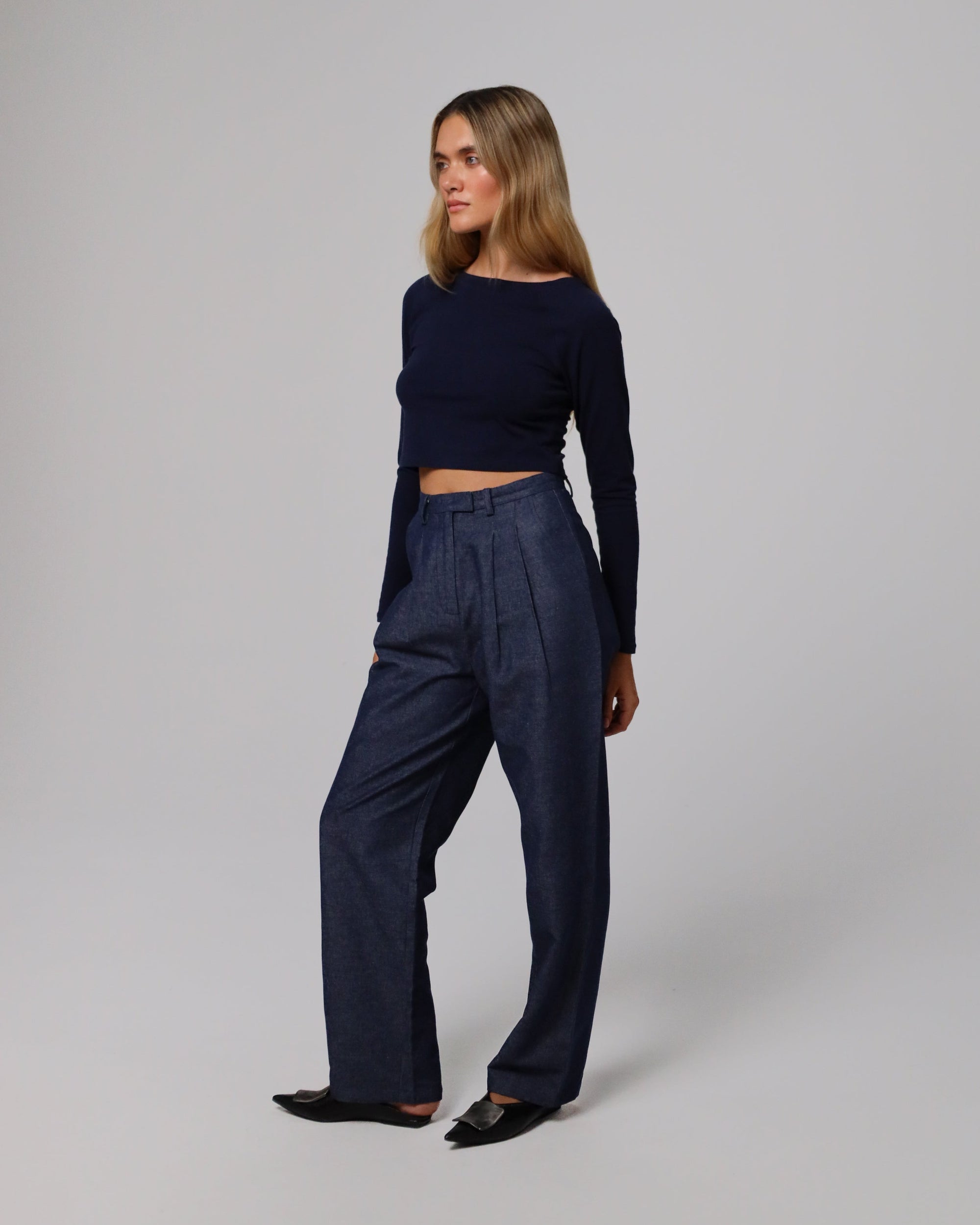 Detail shot of waistband, fly, and seam finishing on Juana High Rise Trousers (indigo denim).