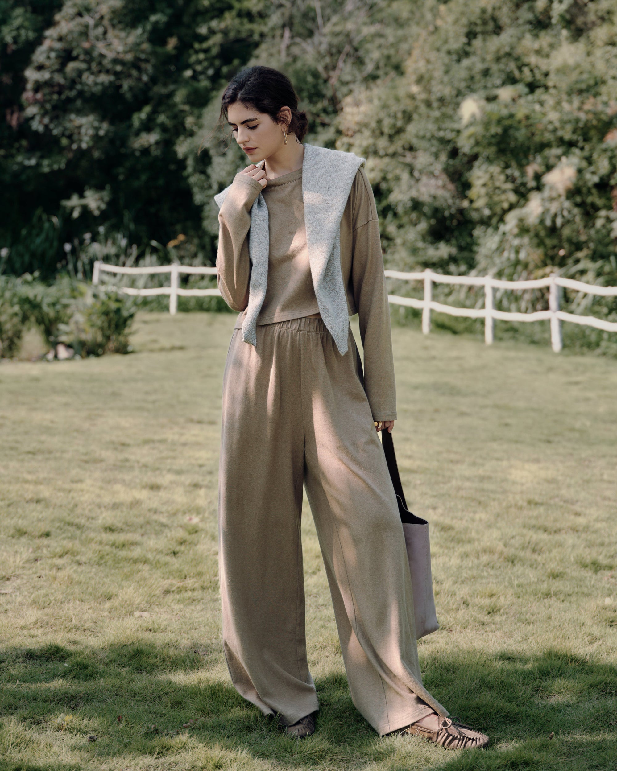 Garden standing shot of Aera set olive (hemp–organic cotton), highlighting boxy silhouette and clean waistband.