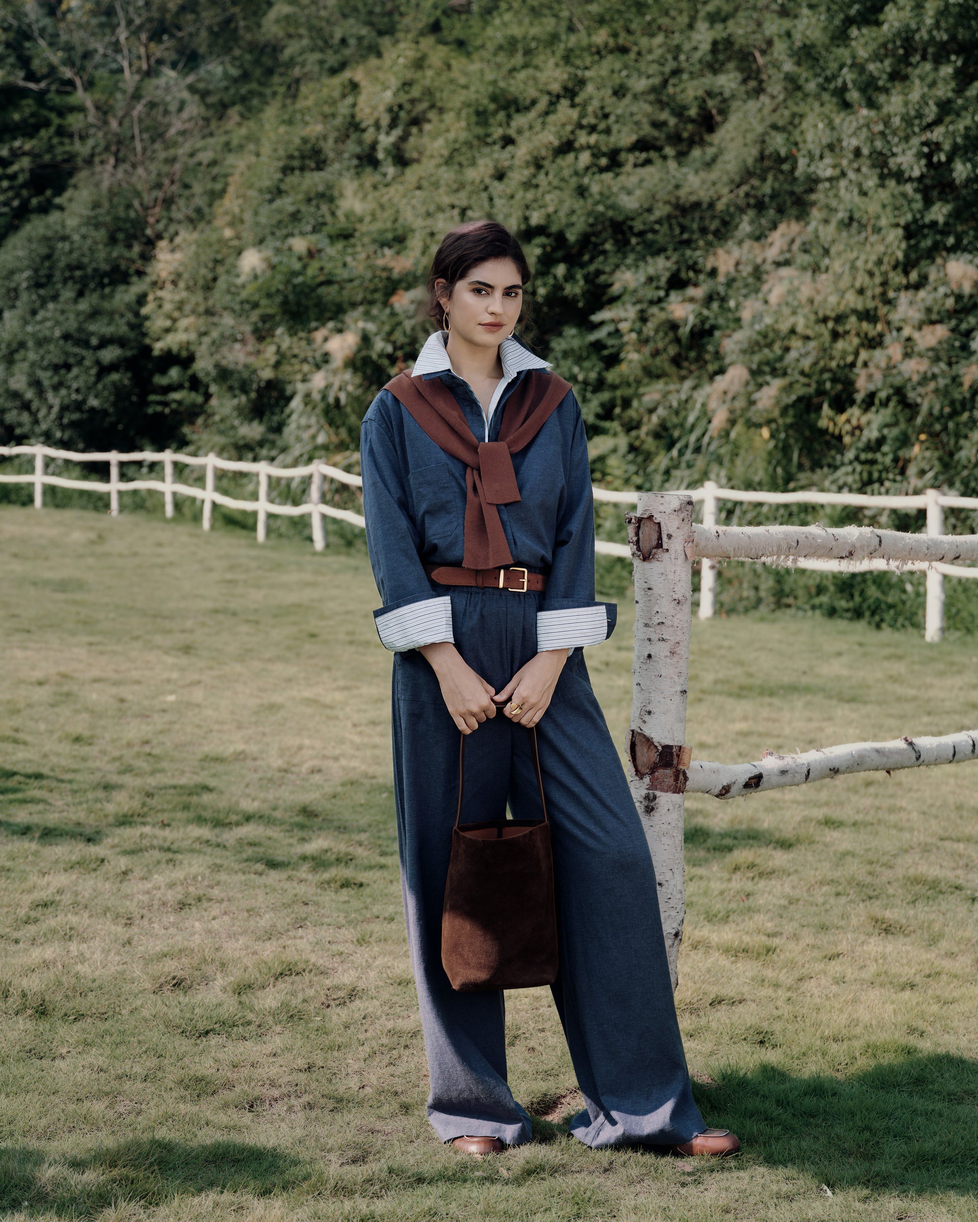 Garden standing shot of Lyricist set indigo blue (hemp–Tencel™) over white shirt; oversized shirt line and easy pull-on waistband visible.